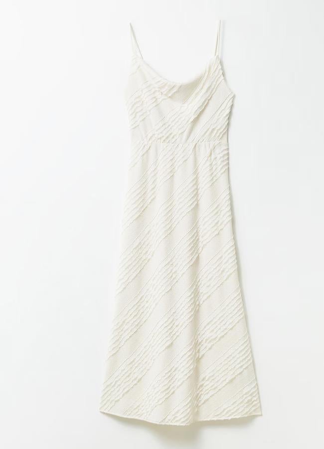 Vestido blanco con acabado lencero de Sfera (29,99 euros).